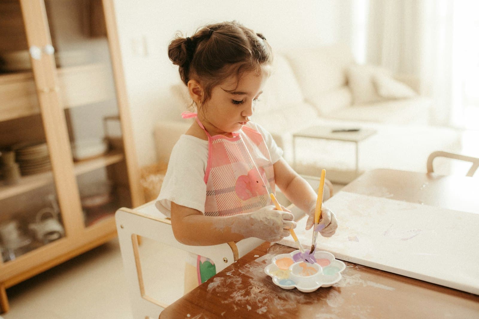 Young child painting at a table