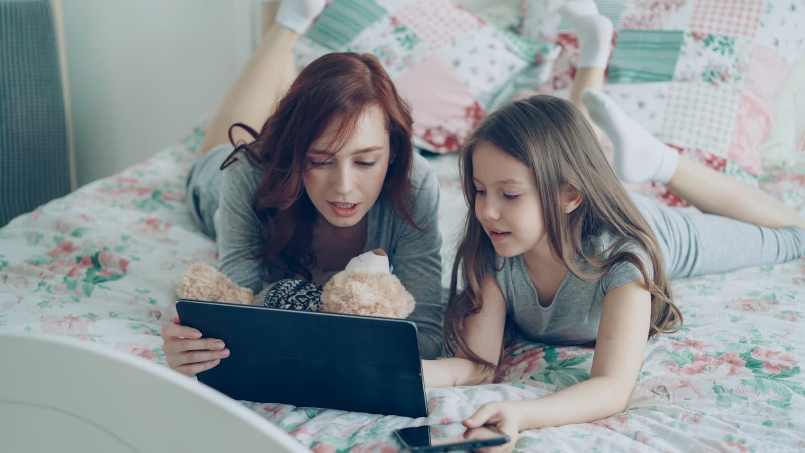 Parent and child looking at a tablet together